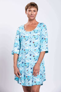 Woman wearing a blue bamboo sleepshirt with ski and mountain print, front view