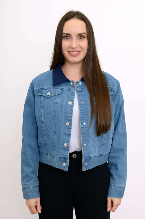 Front view of a woman wearing a cropped blue jean jacket with indigo collar