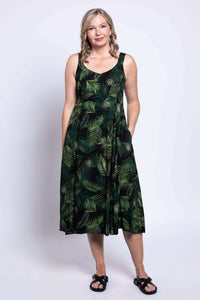 Front view of a woman wearing a green leaf print sleeveless midi dress