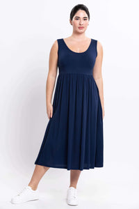 Front view of woman in indigo midi dress with empire waist