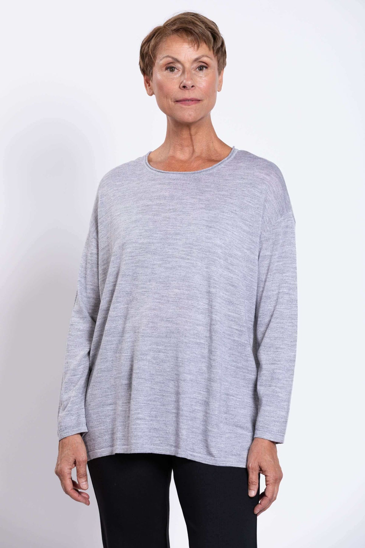 Front view of woman wearing a light grey Merino wool pullover sweater