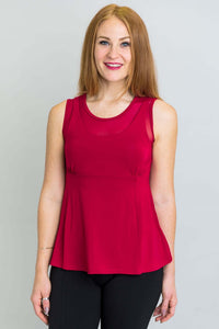 Woman wearing a sleeveless red tank top with mesh neckline, front view