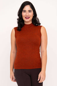 Front view of a woman wearing a rust-colored sleeveless merino wool sweater tank