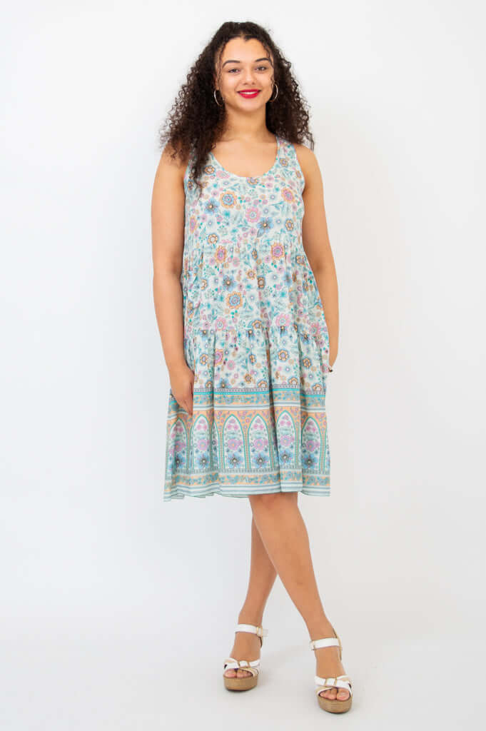 Front view of woman in sleeveless floral tiered dress with a relaxed fit