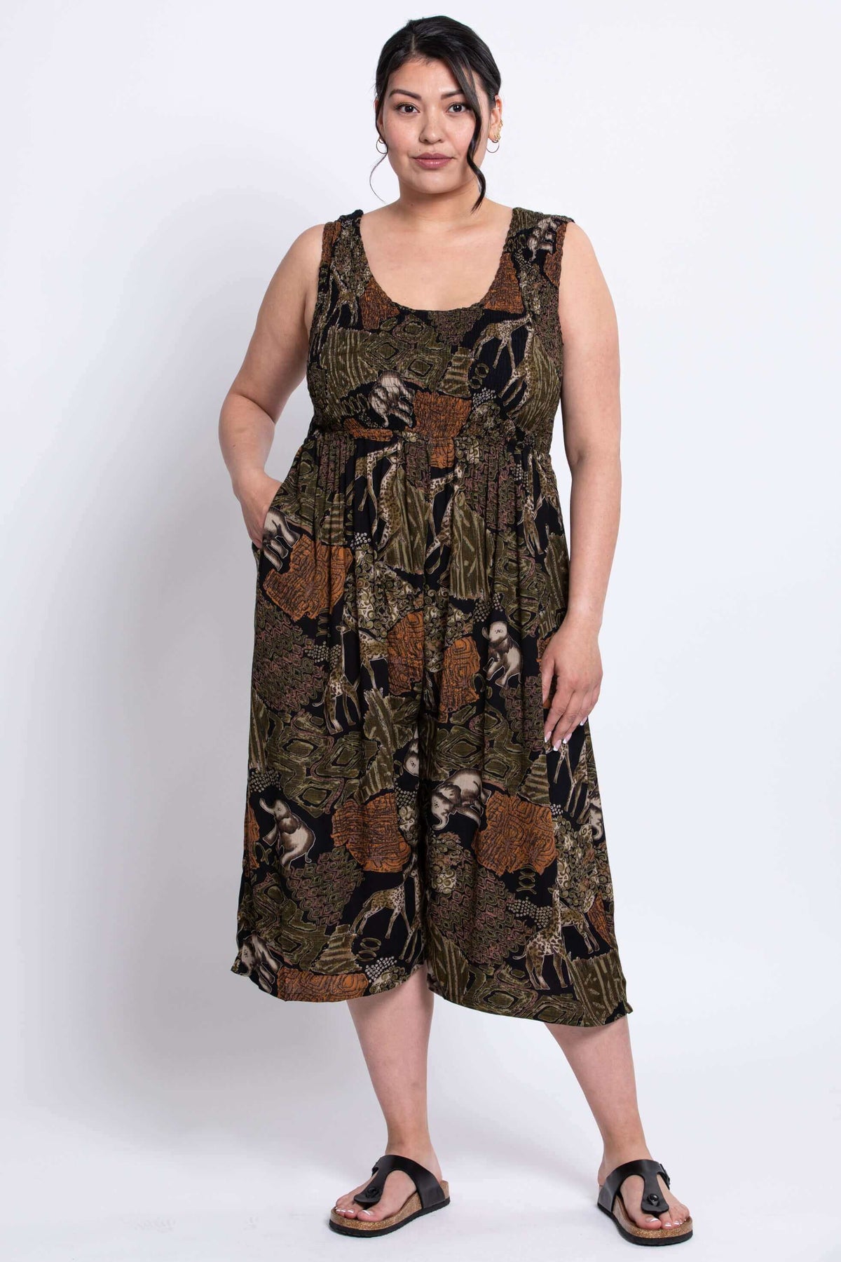 Woman wearing a sleeveless safari print jumpsuit with wide legs, front view