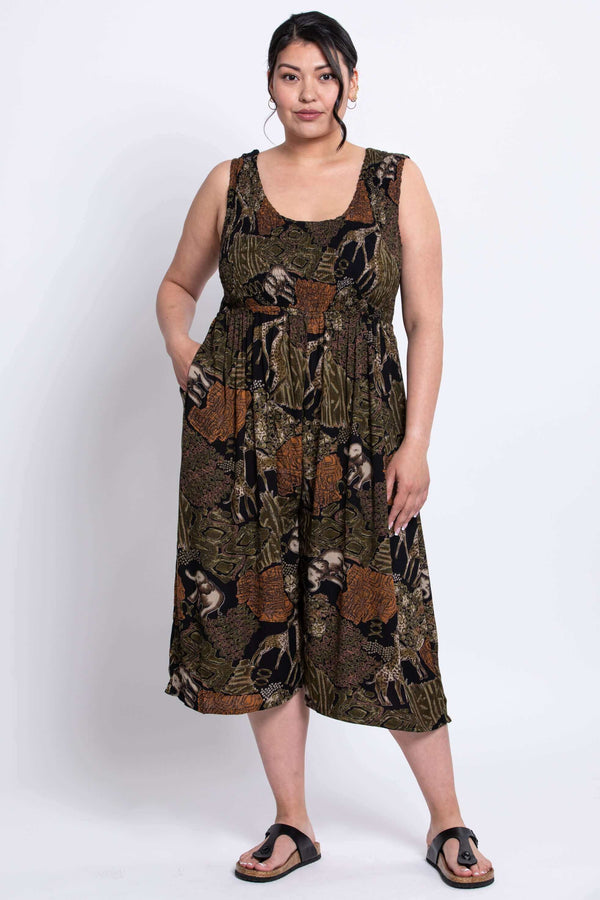 Woman wearing a sleeveless safari print jumpsuit with wide legs, front view