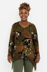 Woman modeling a flowy bohemian top with animal print and green pants, front view