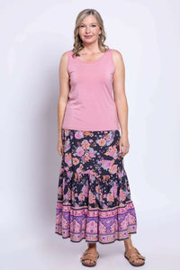 Front view of woman wearing Tibby floral skirt with pink tank top