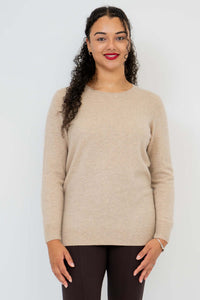 Front view of woman wearing a beige cashmere wool sweater