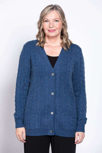 Front view of woman wearing a blue cable knit button-up cardigan