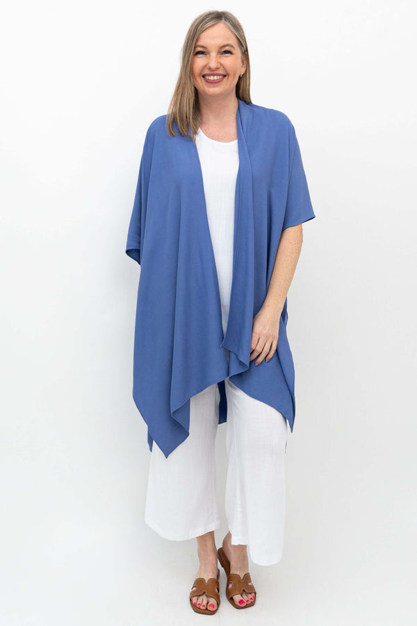 Front view of woman wearing blue Darcy Kimono Wrap over white outfit