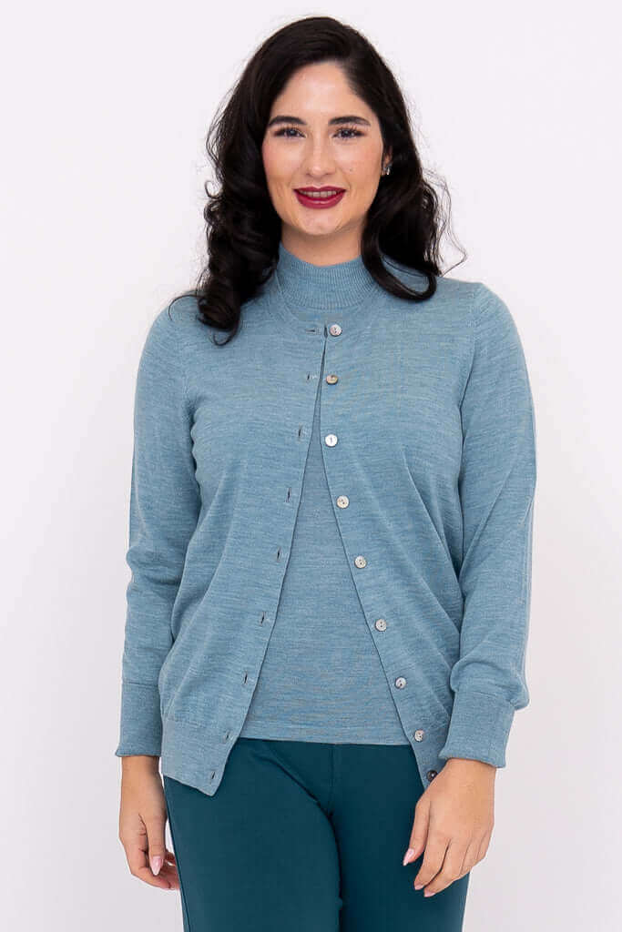 Front view of woman wearing blue Merino wool Kitten Cardigan with crew neck