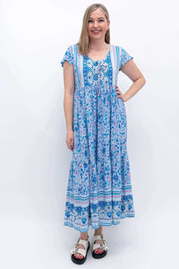 Front view of woman wearing blue floral Sharpie Dress with flutter sleeves