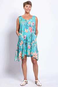 Front view of woman wearing blue floral sleeveless Gia Dress with pockets