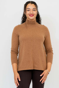Front view of woman wearing camel brown mock neck sweater