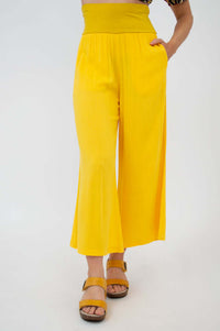 Front view of bright yellow cropped wide-leg capri pants with pocket and high waistband