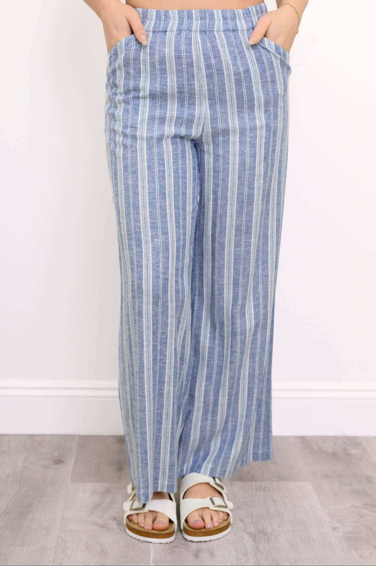 Parker Pant in blue stripes, front view with model's hands in pockets