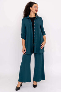 Full-body front view of woman in teal bamboo blouse-jacket and matching wide-leg pants