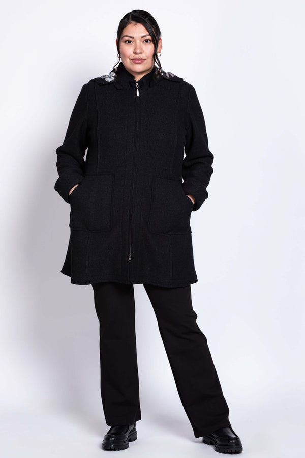 Full-body front view of model in black boiled wool car coat with patch pockets