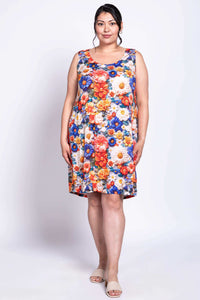 Front full-body view of model in a sleeveless, bright floral shift dress