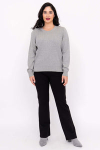 Full-body front view of woman in grey sweater and black pants