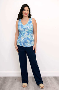 Full-body shot of woman modeling blue reversible bamboo tank top and navy pants