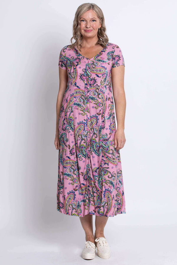 Full-length front view of a woman in a pink paisley print dress with v-neckline