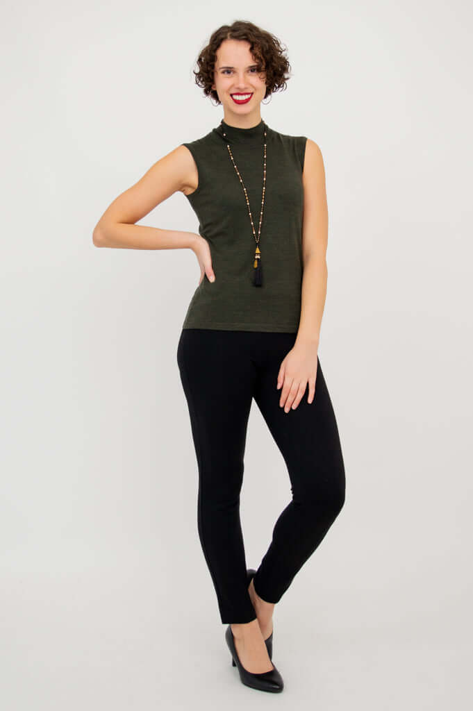 Full-length shot of model wearing the sleeveless Rita Merino Wool Sweater and black pants