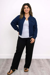 Full-length image of woman modeling a navy blue jean-style jacket with black pants