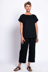Full-length view of woman in black linen blend tee and matching pants