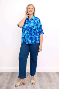 Full-length model wearing Lorine blouse in blue print with blue jeans and sandals