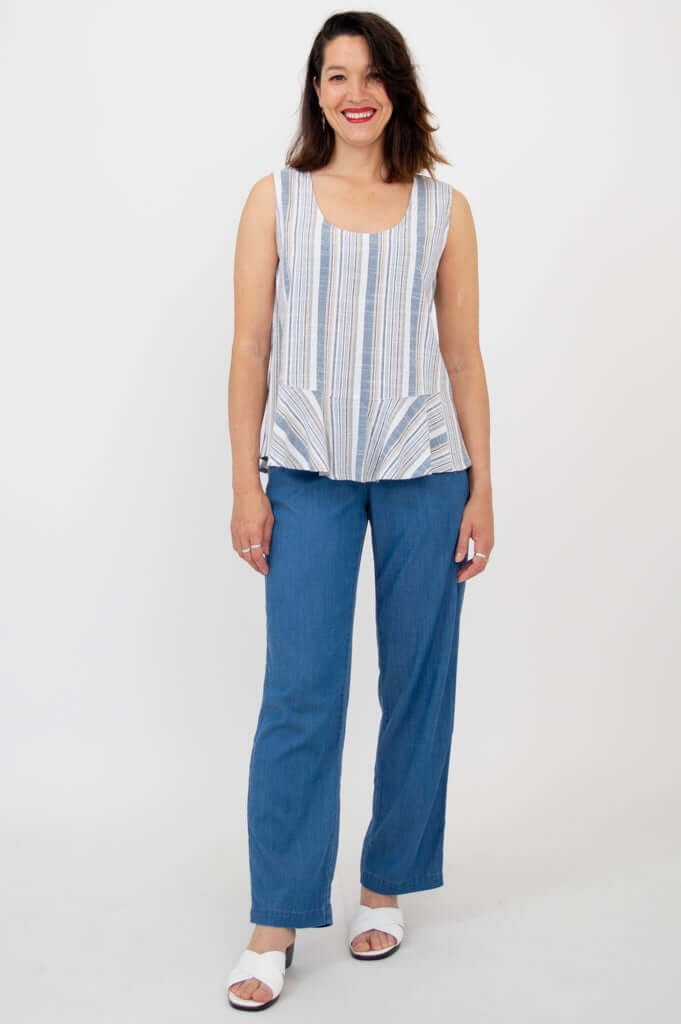 Full body view of model in Ginny Tank paired with blue pants and white sandals