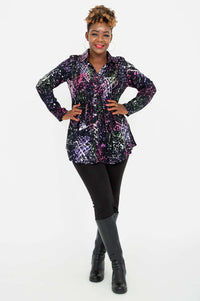 Full body, arms akimbo, of a woman wearing the Cindy smocked long sleeve shirt and black boots