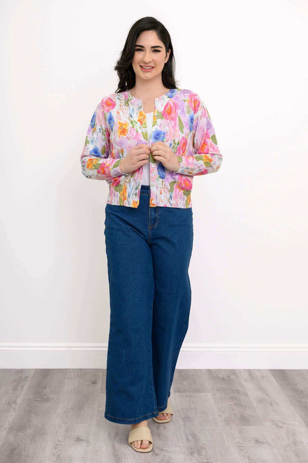 Full body view of woman in floral button-up cardigan paired with wide-leg jeans