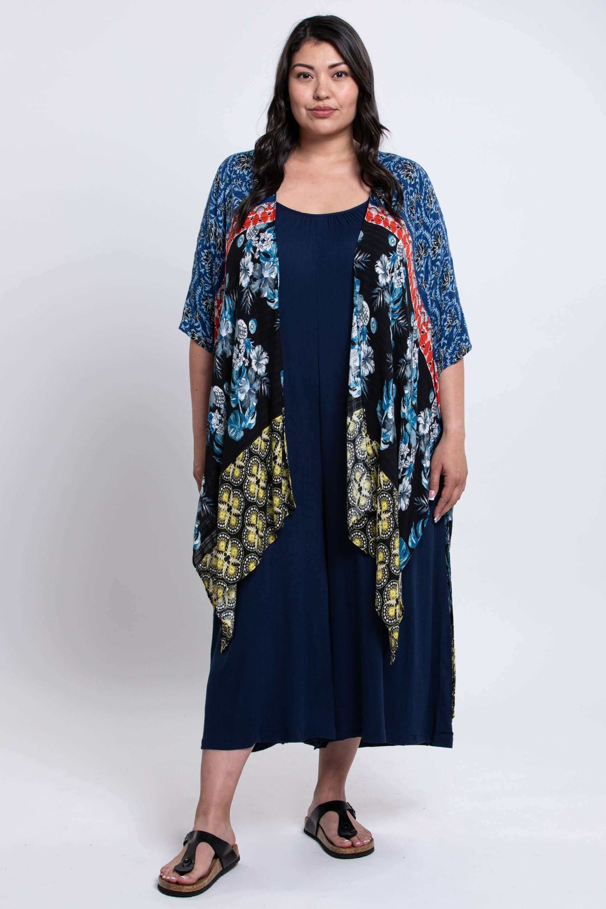 Full body front view of woman modeling Darcy kimono wrap with colorful floral and geometric patterns