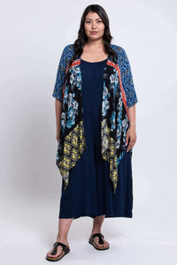 Full body front view of woman modeling Darcy kimono wrap with colorful floral and geometric patterns