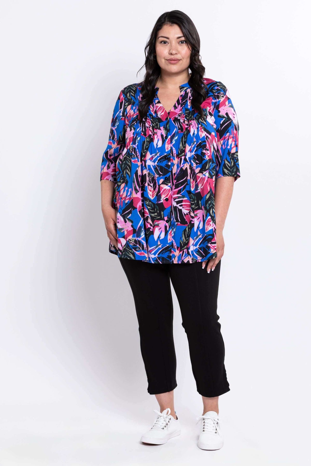 Full body front view of woman modeling Margate blouse in bright botanical print