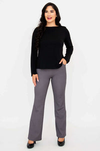 Full body front view of woman in black Mona boat neck top and grey check pants