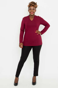 Full front pose of woman in burgundy V-neck bamboo top and black pants