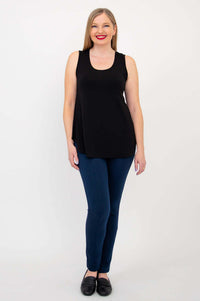 Full front view of woman in black tank top and blue pants