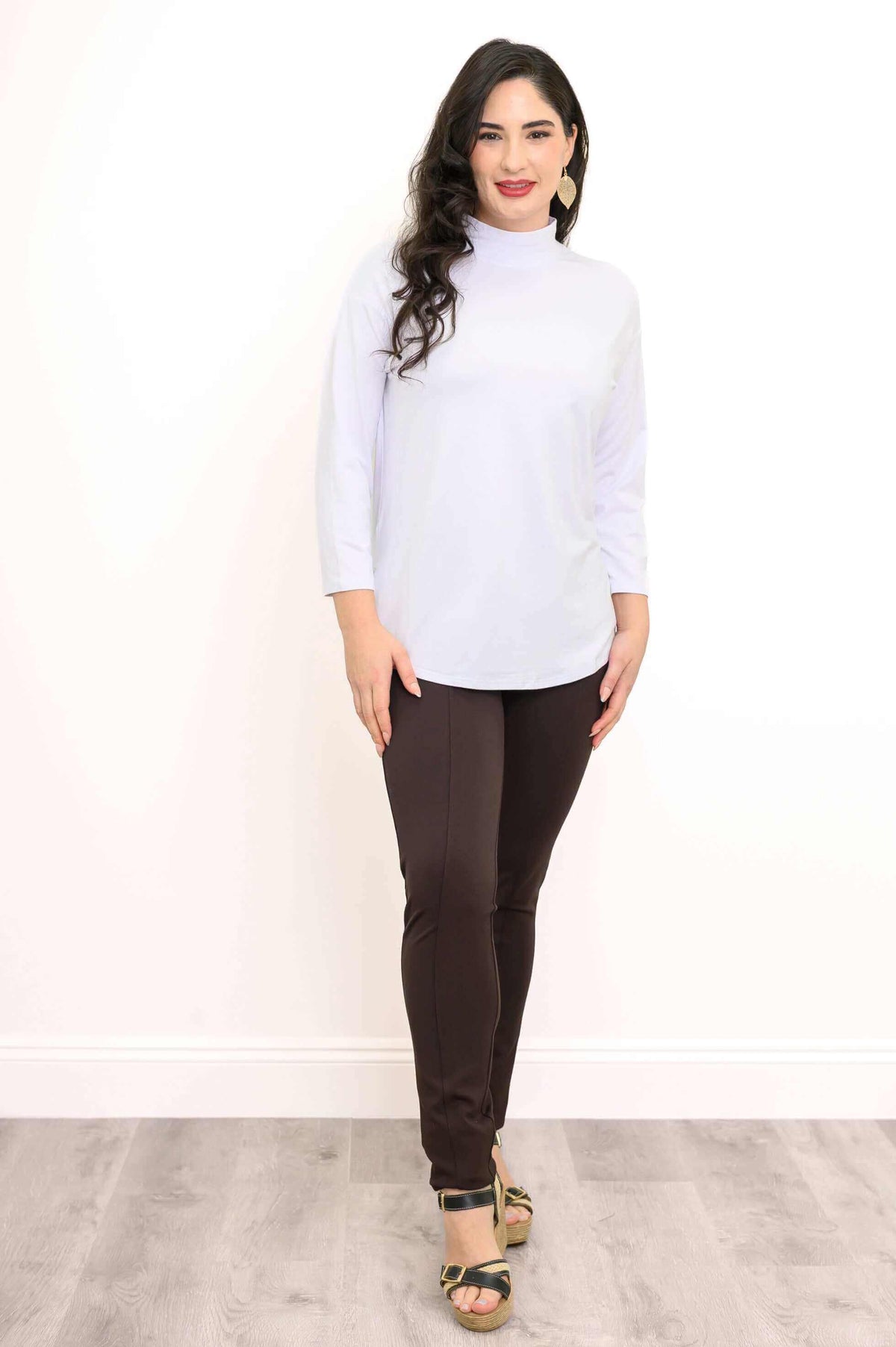 Front full body image of a woman in a white mock neck bamboo top