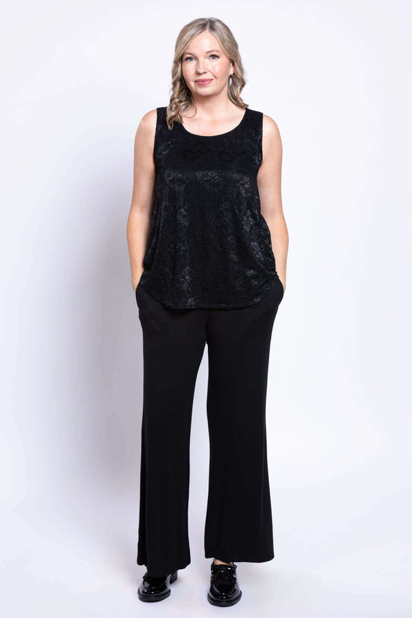 Full body front view of woman in black lace tank and wide-leg pants