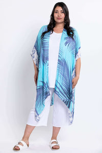 Full body front view of model in blue and turquoise kimono wrap over white outfit