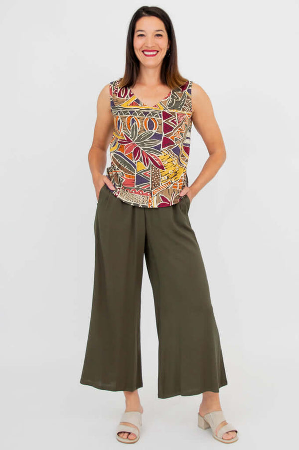 Full length front view of a woman in a sleeveless printed tank and wide leg pants