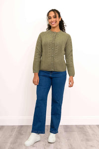 Full body shot of a woman in an olive green cardigan and blue jeans, front view