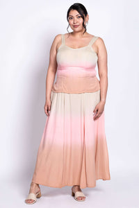 Full body front view of a woman modeling a beige to peach ombre maxi dress