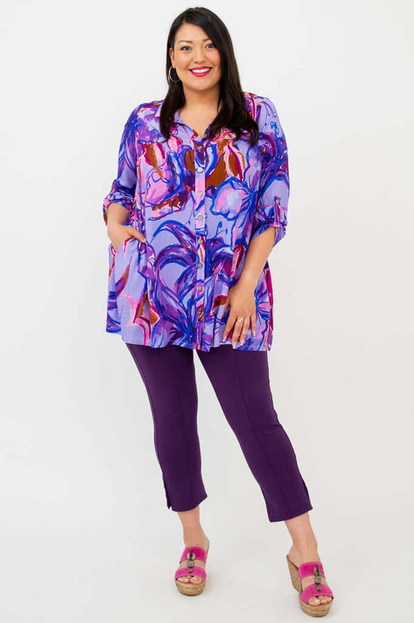Full-length view of model in purple floral tunic, paired with purple capri pants and pink sandals