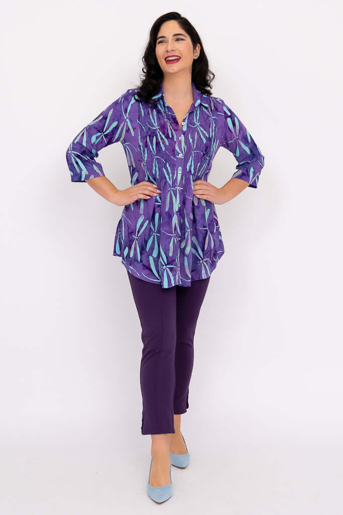 Full body view of model posing in Cindy violet dragonfly smocked blouse and purple pants