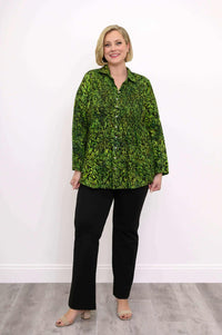 Full body view of model in green leaf smocked shirt and black pants