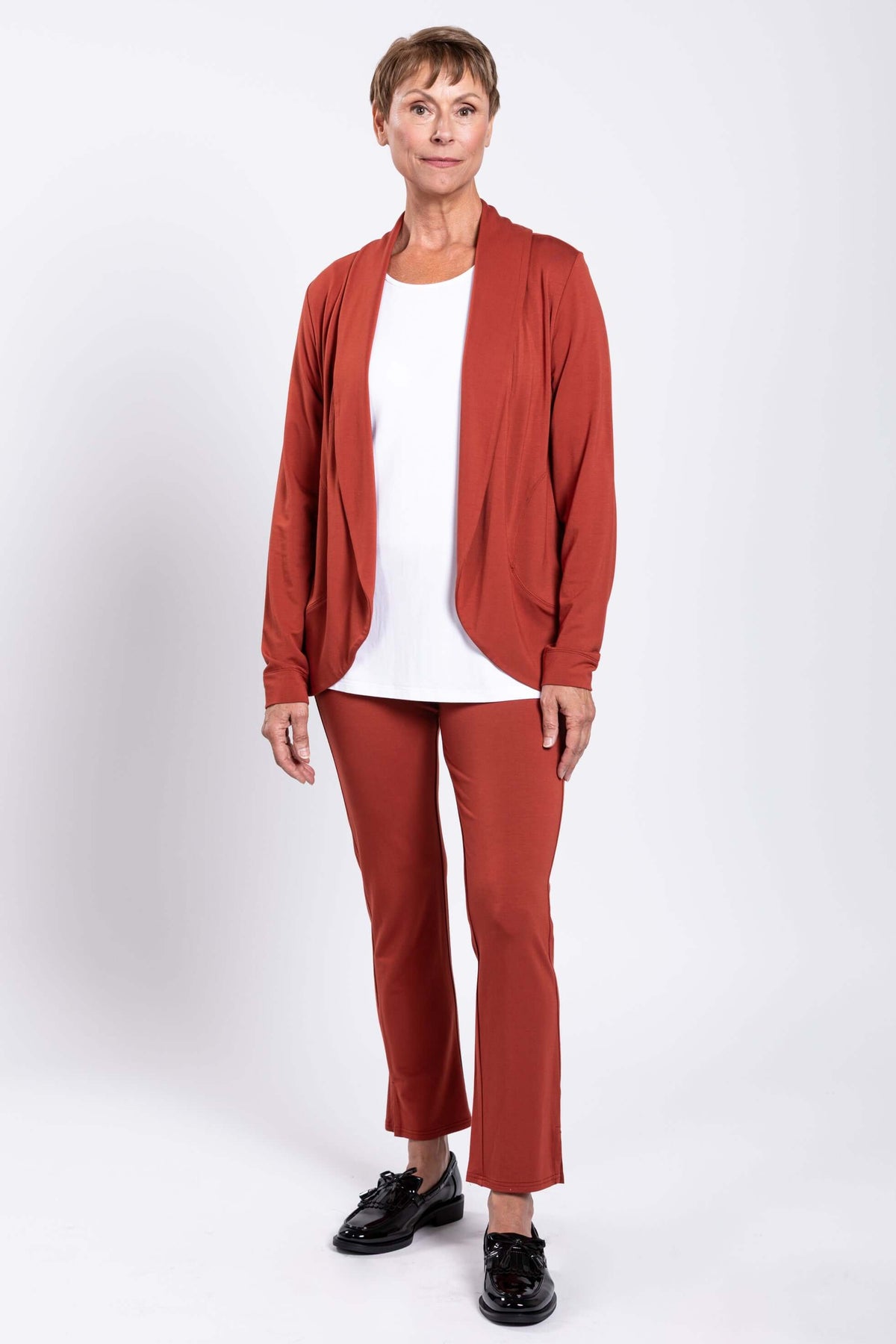 Full body view of woman in rust French Terry jacket and pants with white shirt